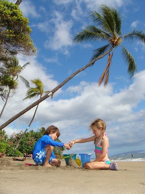photo of children playing in the sand in hawaii